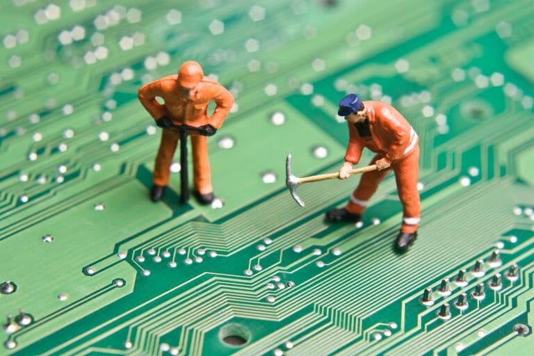 Two men are working on a circuit board while seeking help from Google My Business Support to solve issues.