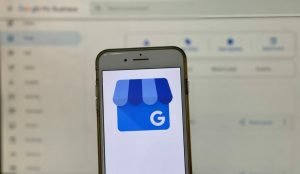 The Google Business Profile logo is displayed on a smart phone.