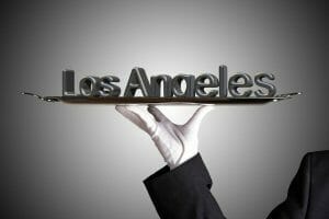 A hand holding a tray with silver letters serving Digital Marketing Services Los Angeles.