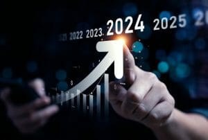 A hand is pointing at an internet marketing service boost graph with the word 2024 on it.